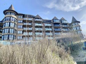 a large building on the side of a beach at Appartement 'Witte Berg' De Panne in De Panne