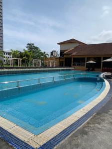 a large swimming pool with blue water at Afamosa Dsavoy Condotel in Kampong Alor Gajah