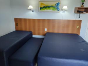a room with two blue beds in a room at Suíte Thermas Place in Caldas Novas +21 photos