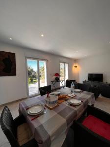 a dining room with a table with chairs and a tableablish at Casa Sognu di Orizonte in Figari