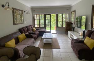 a living room with a couch and a table at Eden Wilds 72 in Port Edward