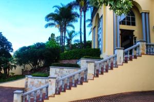 a house with a staircase in front of a building at TDM's Boutique Guest House in Pretoria