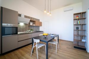 A kitchen or kitchenette at Ortigia Superior Sea View Apartment near Duomo