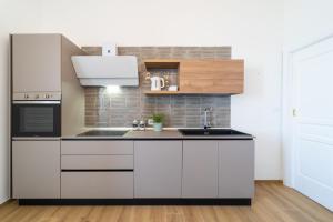 A kitchen or kitchenette at Ortigia Superior Sea View Apartment near Duomo