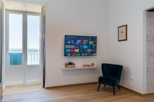 A television and/or entertainment centre at Ortigia Superior Sea View Apartment near Duomo