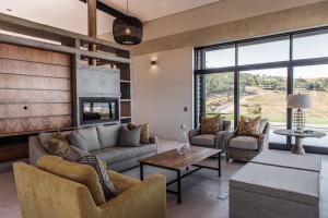 a living room with a couch and a table at Taaibosch Collection in Stellenbosch