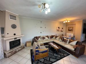 a living room with a couch and a fireplace at Rania House in Limenas