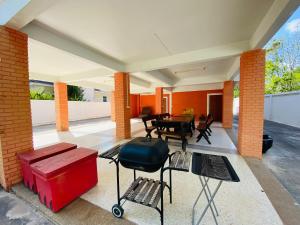 a patio with a table and chairs in a house at Ma Baan House by the sea in Cha Am Beach