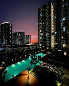 a view of a pool in a city at night at Sofia Homestay Cerrado Southville City Bangi Netflix Wifi in Kampong Tangkas