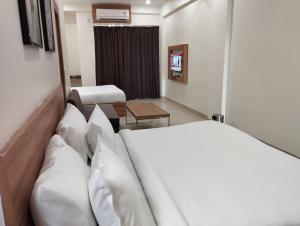 a hotel room with a bed and a table at The Govindam Resort in Vrindāvan