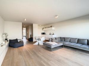 a living room with a couch and a table at Appartement 'Witte Berg' De Panne in De Panne