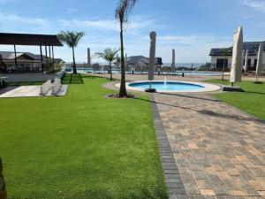 a park with a swimming pool and palm trees at 427 Ballito Hills - Lovely 3 bedroom apartment in Ballito