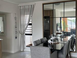 a dining room with a glass table and chairs at 427 Ballito Hills - Lovely 3 bedroom apartment in Ballito