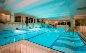 a large swimming pool in a large building at Herzerl Apartment in Sankt Englmar