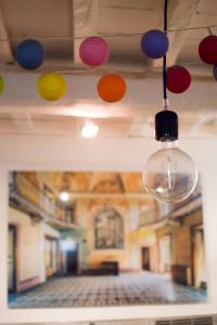 a room with colorful lights hanging from the ceiling at Baudan - Clim - Terrasse in Arles