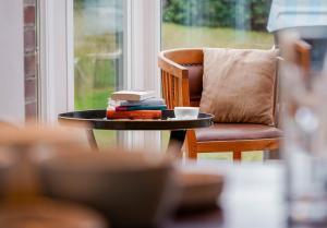 a coffee table with books and a coffee cup on it at Seaside Lodge Sylt in Westerland