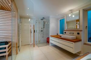 a bathroom with a sink and a shower at Seaside Lodge Sylt in Westerland