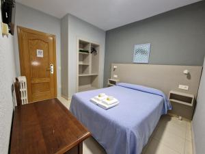A bed or beds in a room at Hostal Soto