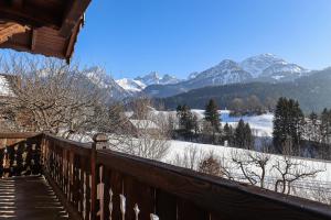 a balcony with a view of a snow covered mountain at Valrose in Chateau-d'Oex