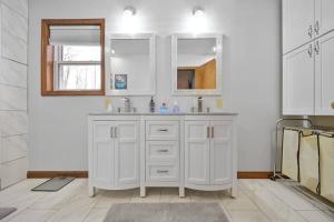 a white bathroom with a sink and a mirror at Newly Renovated! GAME ROOM! Private Bathrooms in Tobyhanna