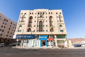 a large building in the middle of a street at Al Eairy Apartments - Al Madinah 09 in Medina