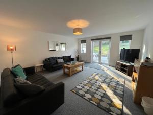 a living room with a couch and a tv at Town House D in Dunston