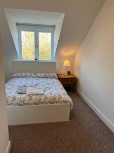 a small bedroom with a bed and a window at Town House D in Dunston
