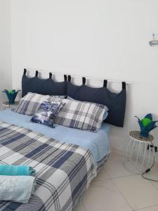 a bed with a blue headboard in a bedroom at Casa Silvia in Caltagirone