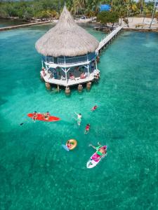 an aerial view of people in the water at a resort at Quinta del Mar Tintipán in Isla Mucura