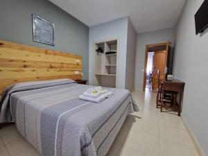 A bed or beds in a room at Hostal Soto