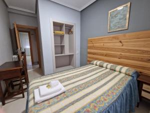 A bed or beds in a room at Hostal Soto