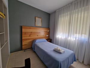 A bed or beds in a room at Hostal Soto