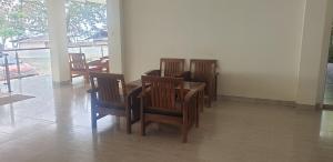 a dining room with wooden chairs and a table at HOTEL CIPUNAGA in Sukabumi