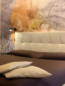 a bedroom with a bed with a white couch and pillows at Locanda La Pernice in Sulzano