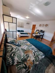 a living room with a bed and a couch at Centenária in Oiã