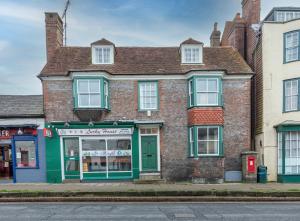 stary ceglany budynek z zielonym przycinaniem na ulicy w obiekcie Historic Spacious Central 6 BR Town House Uckfield Sussex w mieście Uckfield