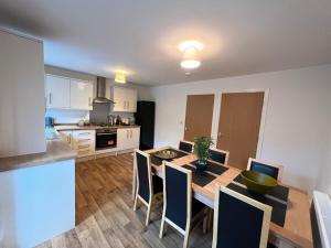 a kitchen and dining room with a table and chairs at Townhouse (C) in private grounds 8 mins from city in Dunston