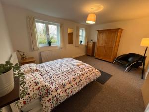a bedroom with a bed and a chair in it at Townhouse (C) in private grounds 8 mins from city in Dunston