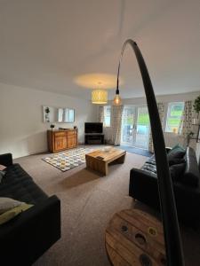 a living room with a couch and a coffee table at Townhouse (C) in private grounds 8 mins from city in Dunston