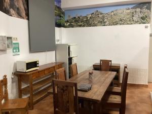 a dining room with a wooden table and chairs at Hostel Rural Gaitanes, Caminito del Rey, Ardales in Ardales
