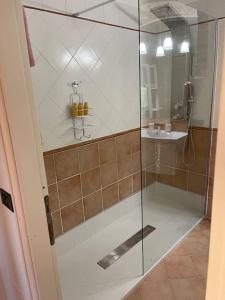 a shower with a glass door in a bathroom at Atelier Fuori Città in Perugia
