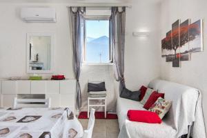 a living room with a bed and a window at Casa sul Lago di Como in Pianello Del Lario