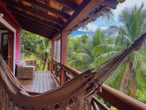a hammock on a porch of a resort at Mooi Guest House in Ilhabela