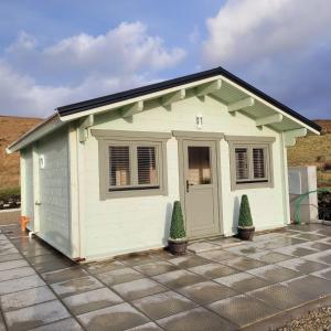 a small shed on top of a driveway at Dolmen Lodge. in Donegal