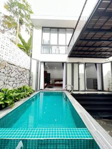 a swimming pool in front of a house at Homestay Luna mountain & sea views! in Vung Tau
