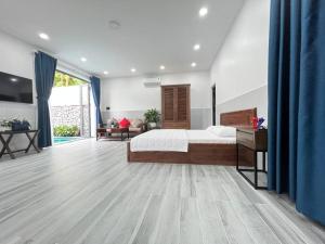 a large bedroom with a bed and a large window at Homestay Luna mountain & sea views! in Vung Tau