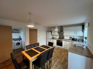 a kitchen and dining room with a table and chairs at Town House B in Dunston