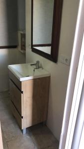 a bathroom with a sink and a mirror at Mirador de Garciez in Torre del Campo