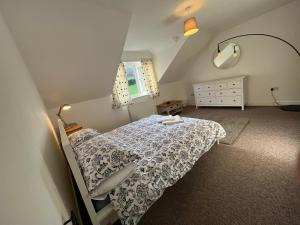a small bedroom with a bed and a mirror at Town House B in Dunston