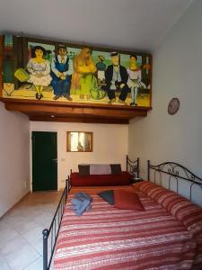 a bedroom with a bed with a painting on the wall at Pisa Train Stop in Pisa